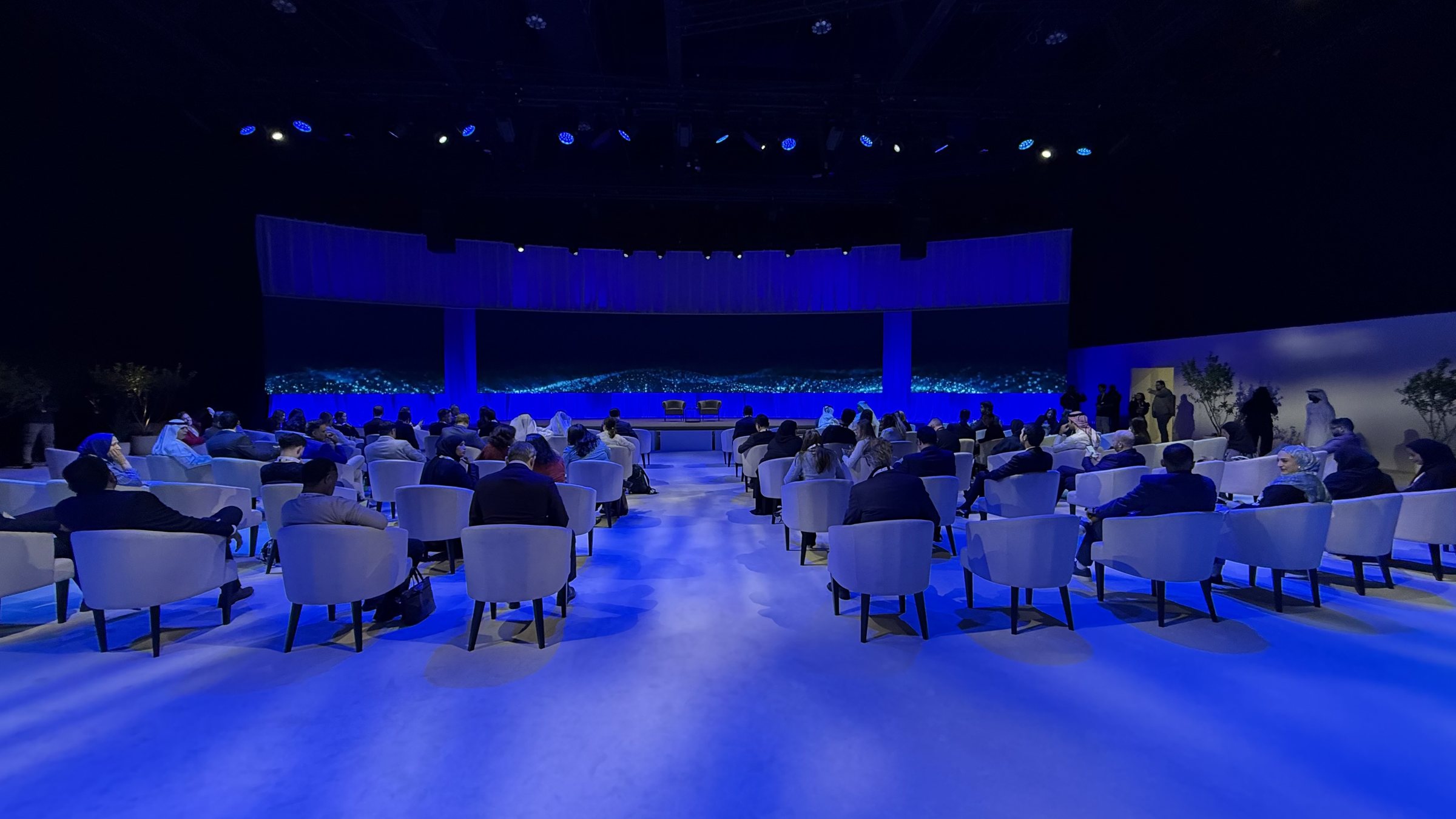 Attendees seated at a Scalable-produced networking event, facing a lit stage in a large venue